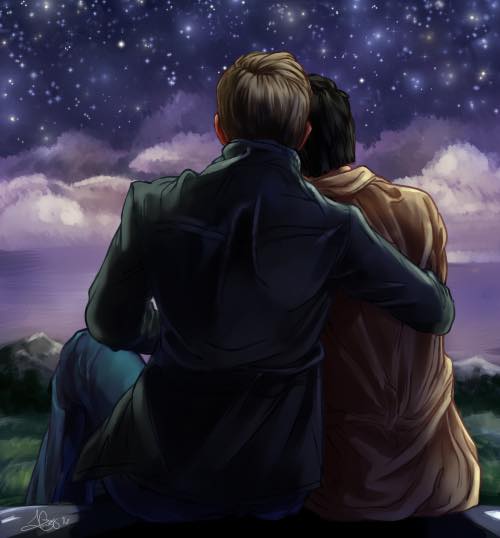 Male lovers on steps looking at starlit night skies