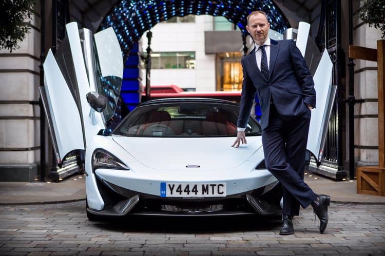 Mark Gatiss poses with a 2019 Mclaren 570s Spider sports car.