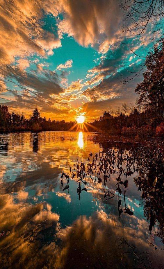 Amazing photo of a sunset over a lake by Journé Germain