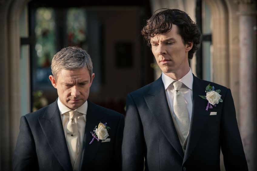 John and Sherlock in wedding finery having a serious conversation outside of church