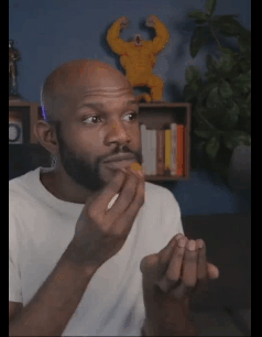 male popping candy while watching insanity on computer