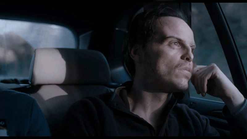Moriarty in back seat of car, thinking