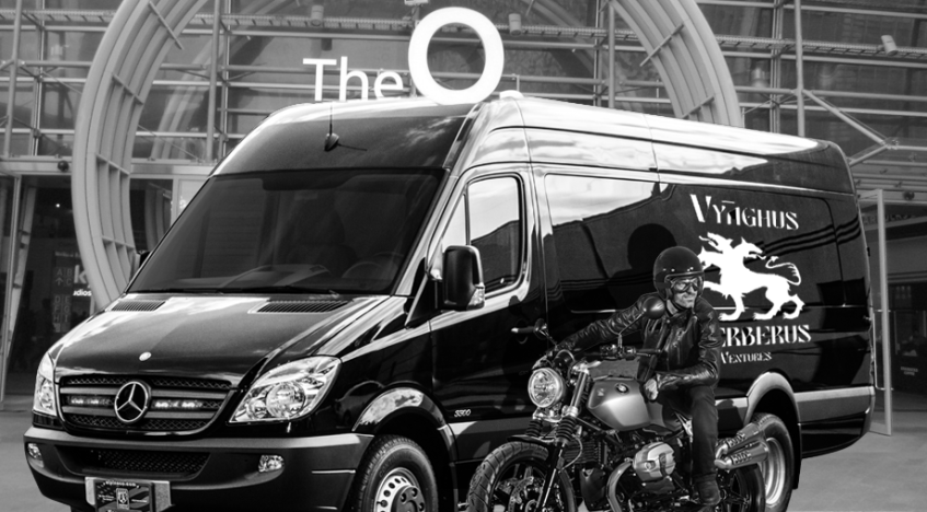 Sebastian on motorcycle in front of Vyāghuṣ Cerberus truck at O2 Arena entrance