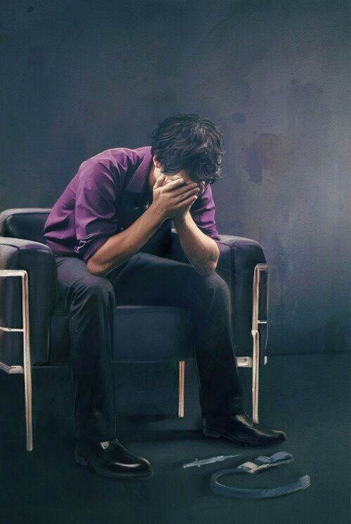 Sherlock, in his chair, head in hands, drug paraphernalia at his feet