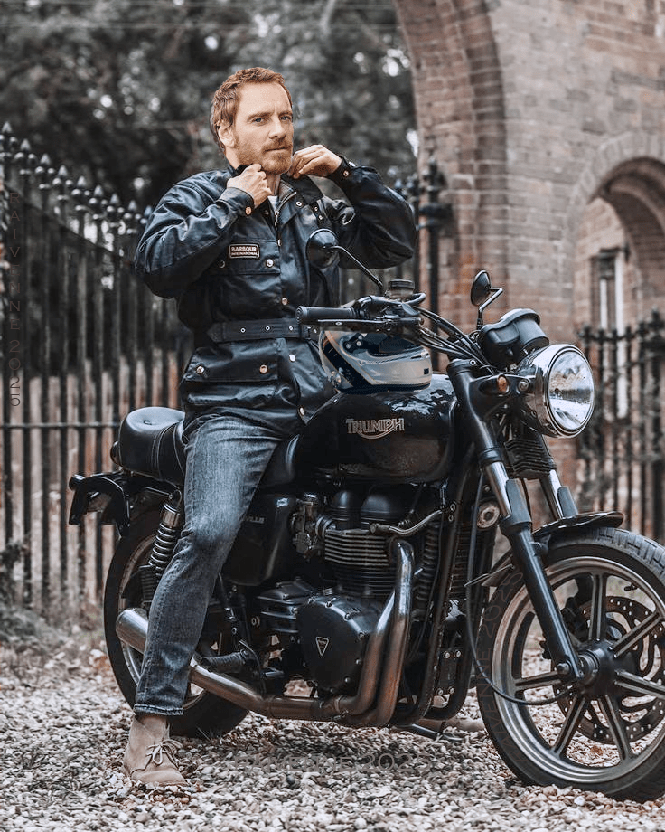 Sebastian on motorcycle at Omera gates